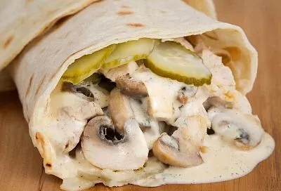 Первый тост — и рулета уже нет. Это блюдо из лаваша с куриным филе, грибами и соленым огурцом. Вкус знакомый, но форма — беспроигрышная