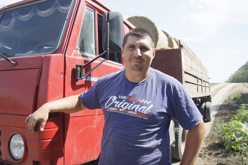 Водитель Лев Монастырский работает на заготовке соломы для молочно-товарной фермы.